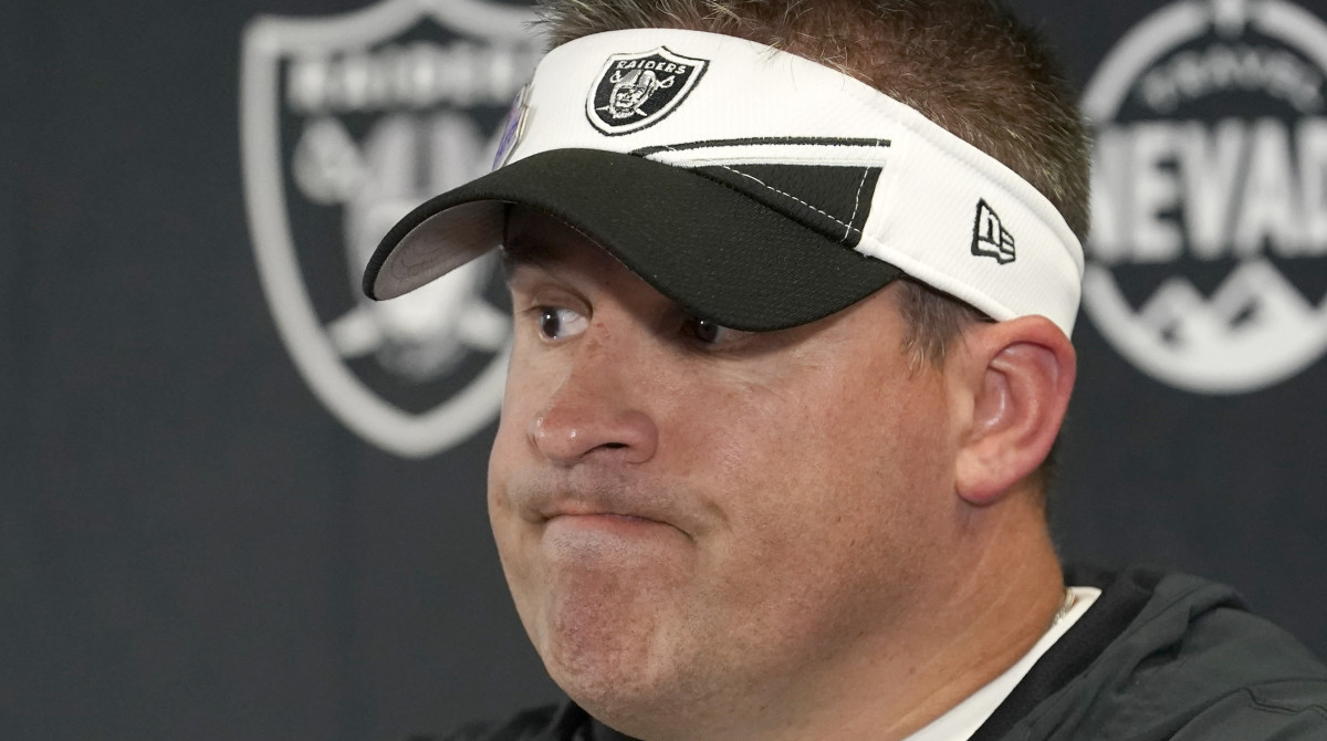 Raiders head coach Josh McDaniels grimaces at a press conference